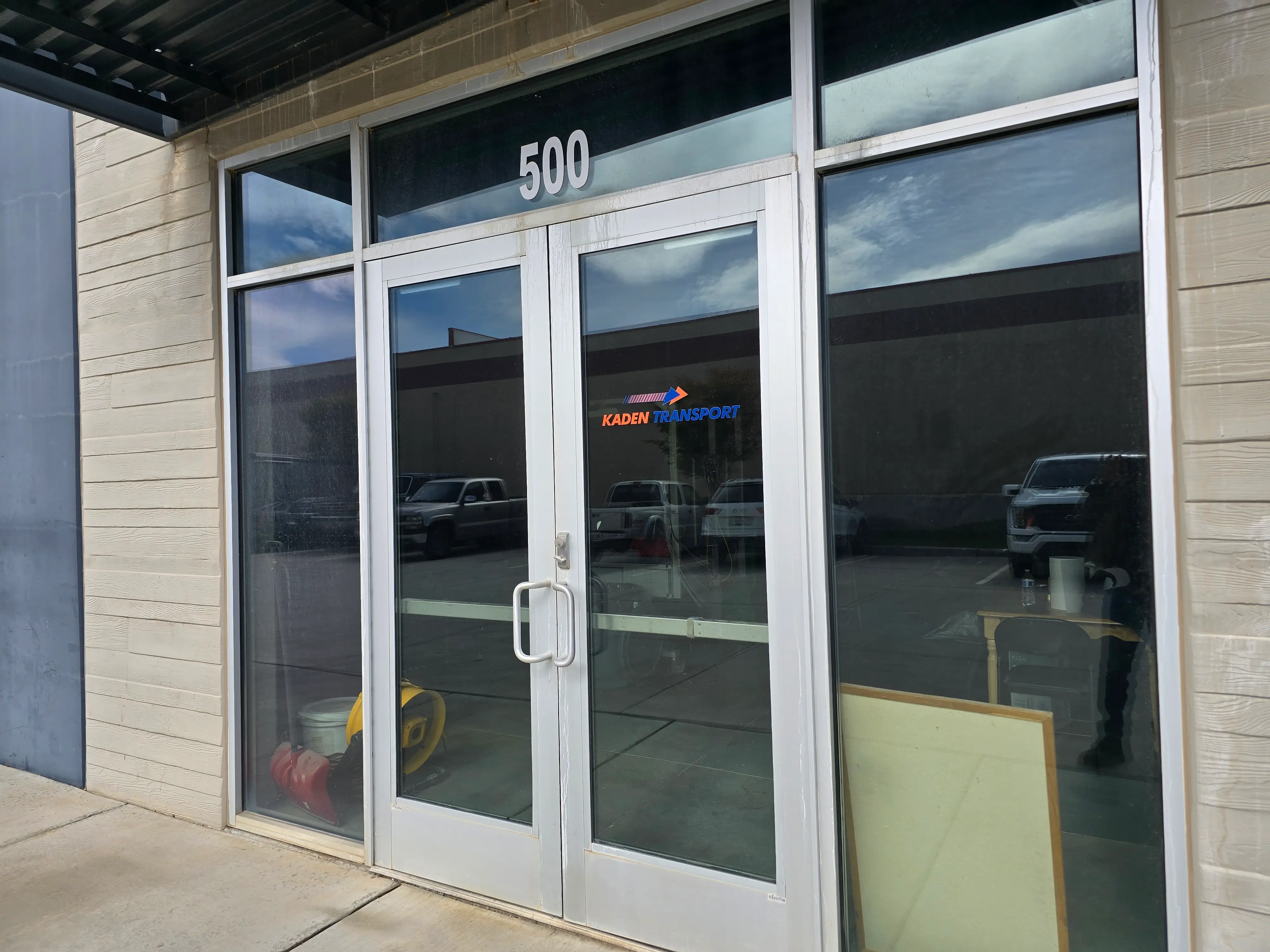 The glass entrance doors marked 500, with the Kaden Transport logo on the glass.